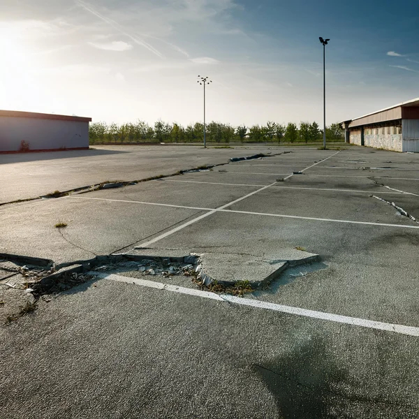 An image showing a commercial parking lot that needs concrete leveling in San Antonio.